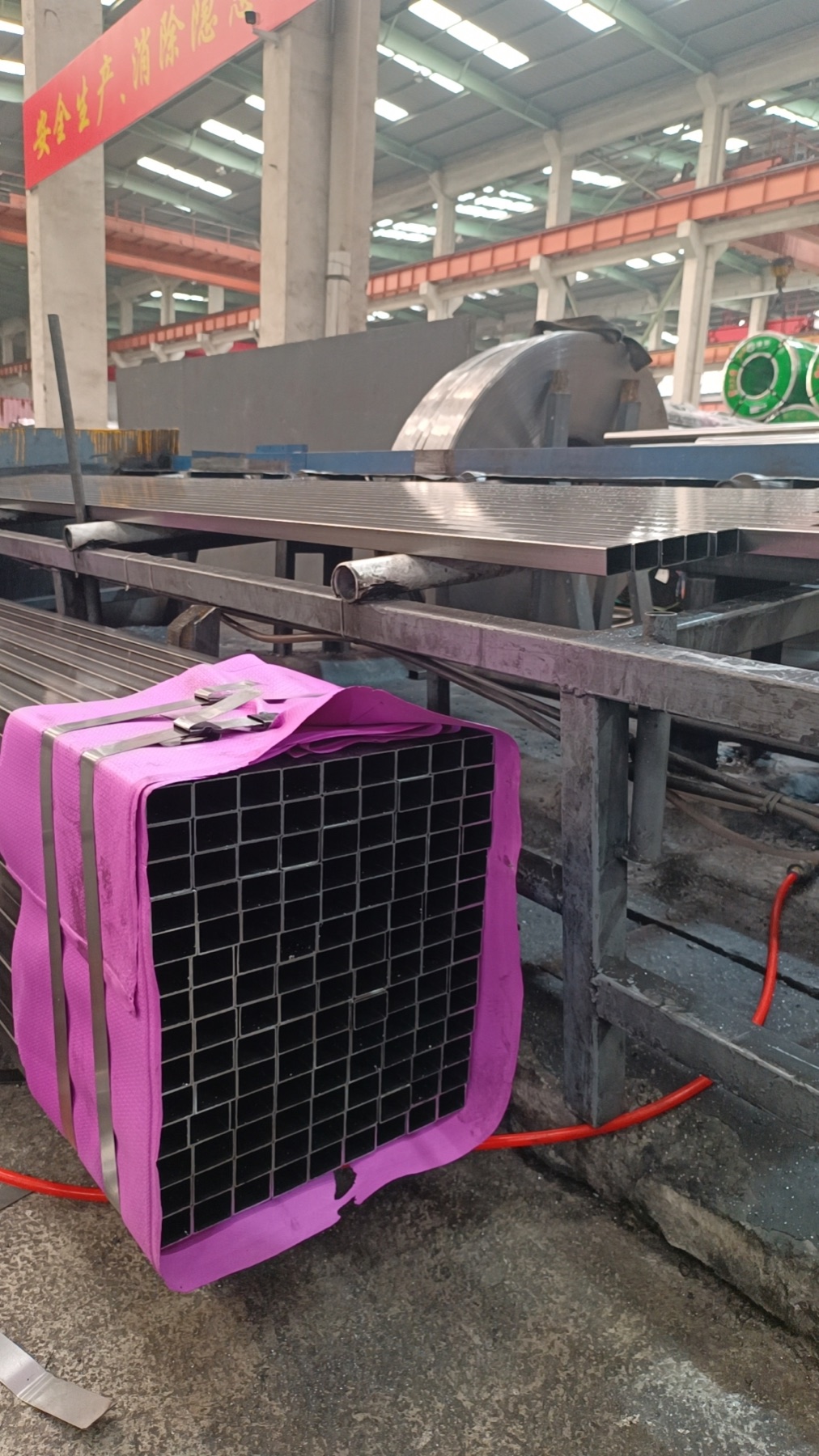Finished square ERW steel tube bundle on the production floor